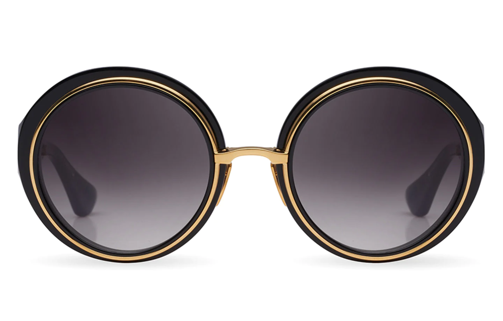 A close up shot of DITA MICRO-ROUND DTS406-A sunglasses in Black - Yellow Gold (lens is Dark Grey to Clear Gradient) DTS406-A-01.